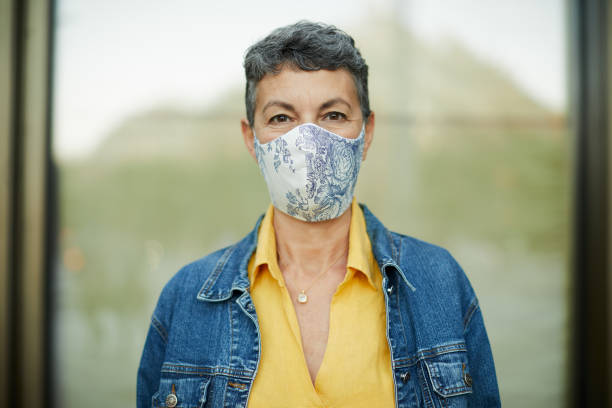 istock One woman wearing a protective face mask and looking at camera. 1273833786