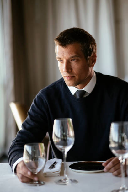 istock Handsome businessman dressed in the suit drinking wine. 1273833805