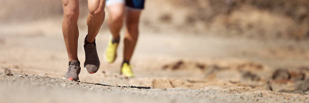 istock Runners running shoes on trail run 1273836263