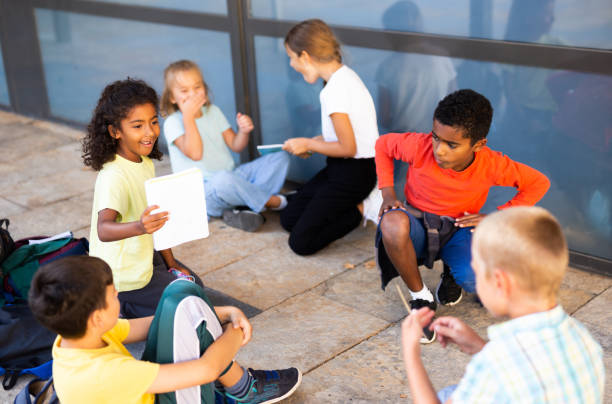 istock Group of children playing near school 1273836426