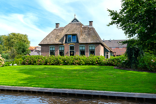 Giethoorn, Netherlands - 13 September 2020. Beautiful thatched buildings in the famous village of Giethoorn in the Netherlands with water canals. The village is called the Venice of the Netherlands.