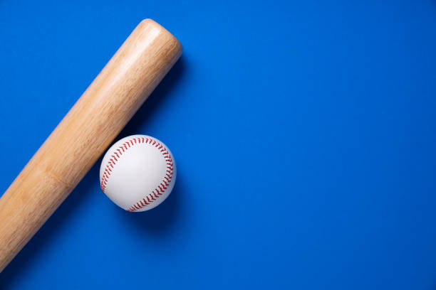 istock baseball and baseball bat on blue table background, close up 1273837927