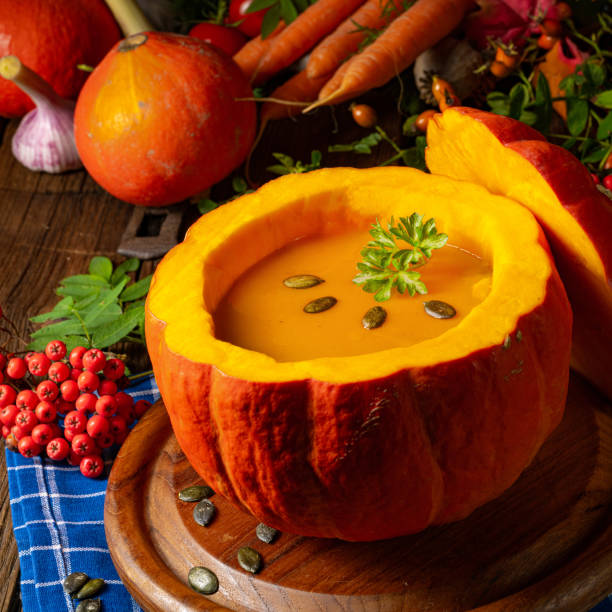 Delicious autumn pumpkin soup with baguette Delicious autumn pumpkin soup with baguette pumpkin soup photos stock pictures, royalty-free photos & images