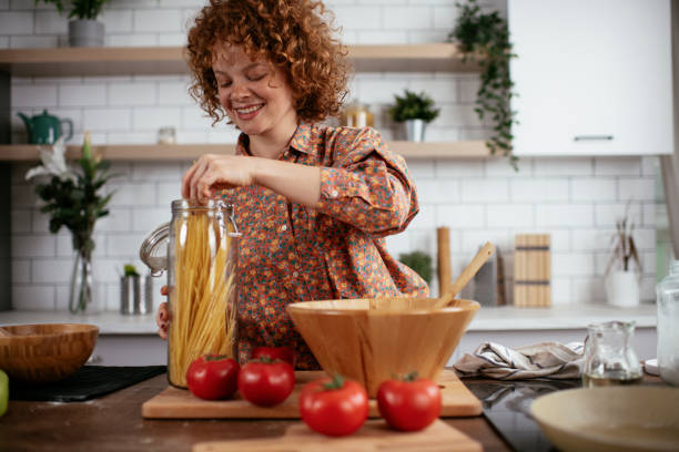 istock Beautiful woman making pasta 1273838194