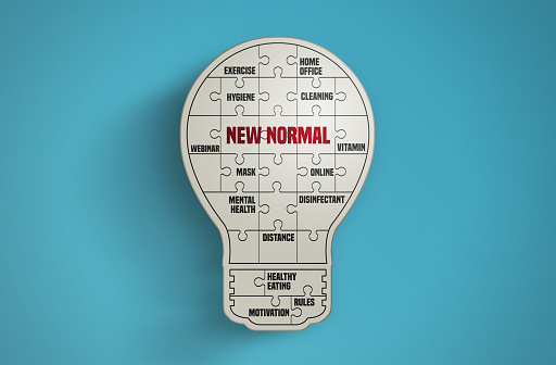 Light bulb puzzle pieces forming the word New Normal on blue background. Idea and New Normal Concept. Horizontal composition with copy space.