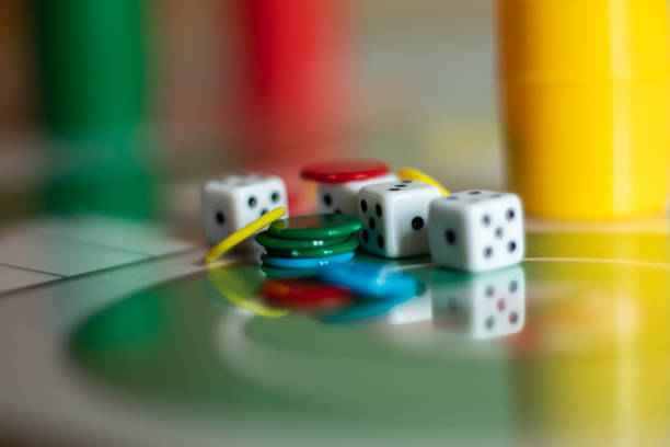 istock Yellow, green and red plastic dice and chips in children's board games. 1273840918