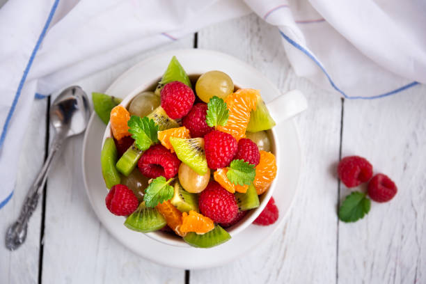 istock Fresh fruit salad with with raspberry, mandarin and other fruit 1273841245