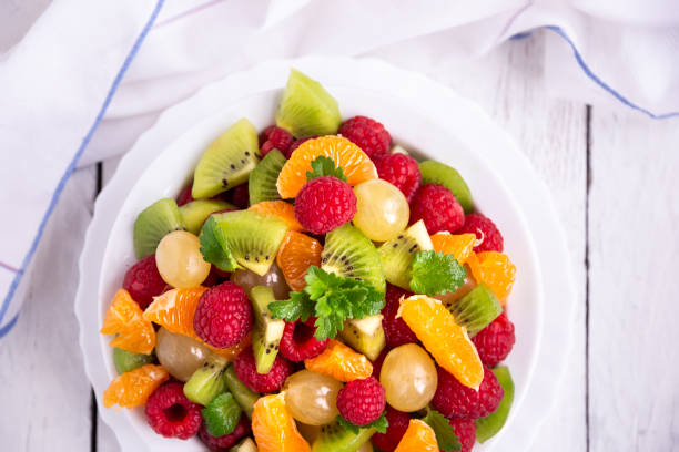 istock Fresh fruit salad with with raspberry, mandarin and other fruit 1273841376