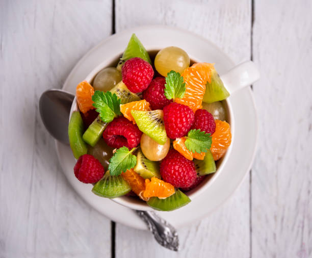 istock Fresh fruit salad with with raspberry, mandarin and other fruit 1273841387
