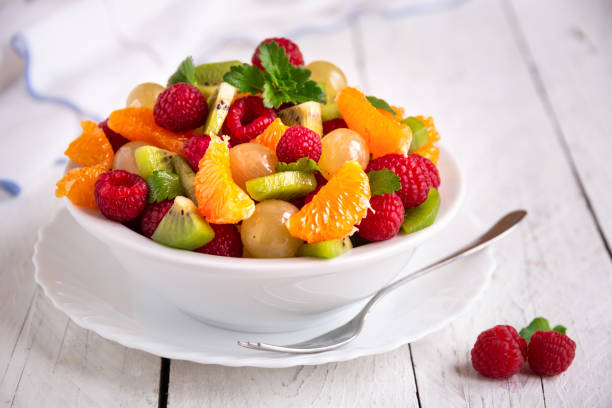 istock Fresh fruit salad with with raspberry, mandarin and other fruit 1273841437