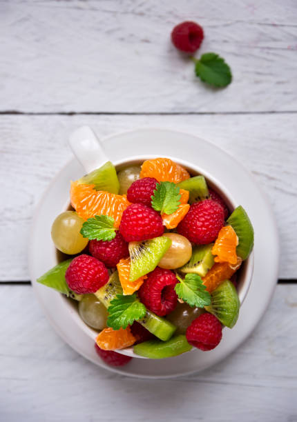 istock Fresh fruit salad with with raspberry, mandarin and other fruit 1273841520