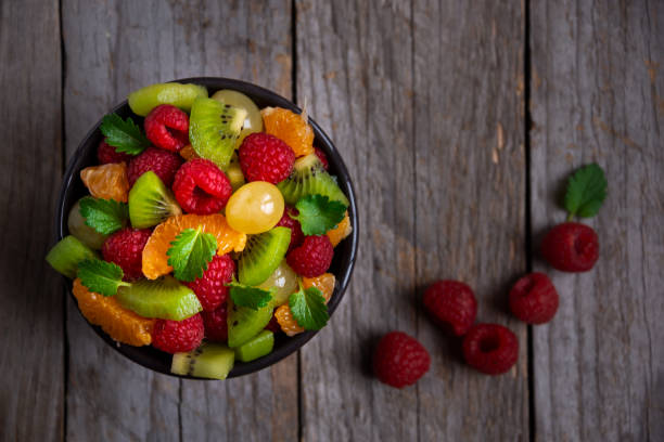 istock Fresh fruit salad with with raspberry, mandarin and other fruit 1273841813