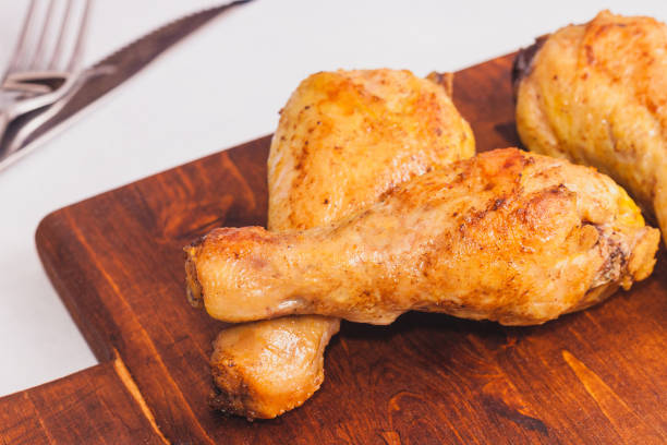 istock Fried crispy chicken legs, Thigh wooden cutting board with spice on table 1273844730