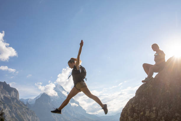istock Female hikers relax on mountain ridge at sunrise 1273845399