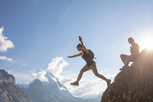 istock Female hikers relax on mountain ridge at sunrise 1273845428