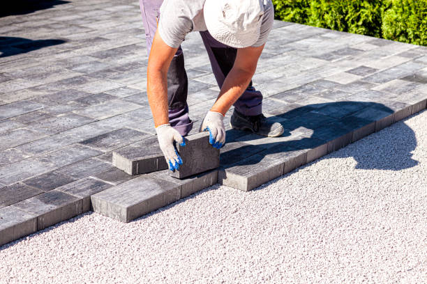 istock Paver arranges cement paving stones 1273845450