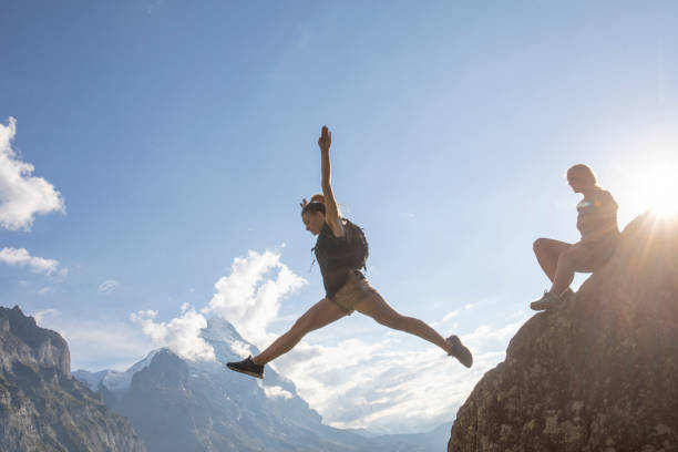 istock Female hikers relax on mountain ridge at sunrise 1273845474