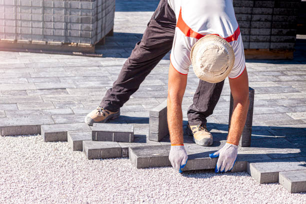 istock Paver arranges cement paving stones 1273845476