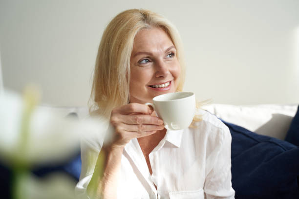 istock Smiling pretty lady is enjoying hot drink 1273845672