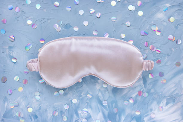 istock Pink satin eye sleeping mask and foil confetti 1273846793