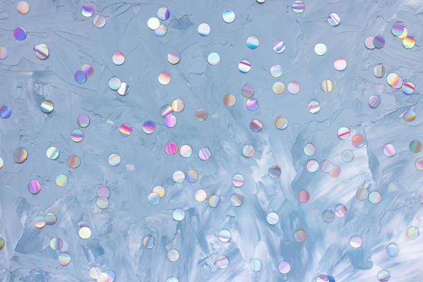 istock Silver foil confetti on white and blue background 1273846795