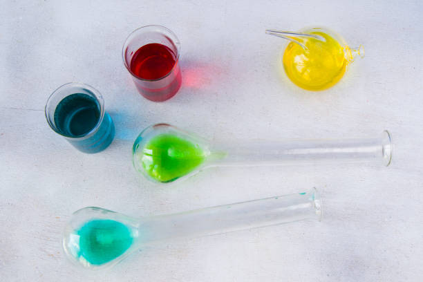 istock Laboratory glassware with colored reagents on the white background 1273847327