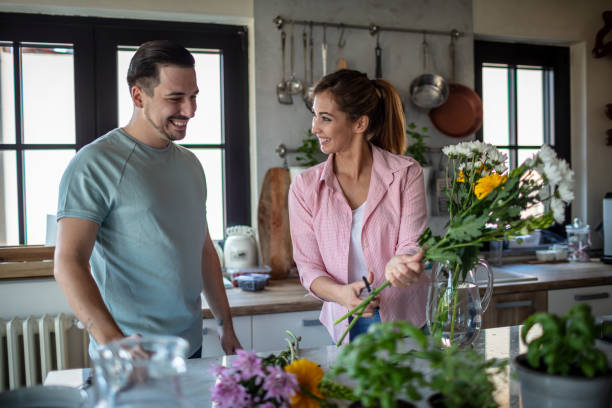 istock Couple arranging a flowers at home 1273849870