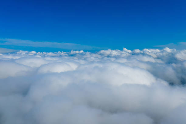 istock Light clouds seen from airplane. Blue endless sky above fluffy clouds. 1273850383