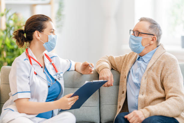 istock Doctor and senior man wearing facemasks 1273852191