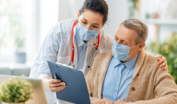 istock Doctor and senior man wearing facemasks 1273852361