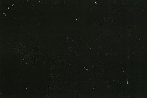 A close-up scan of an old scratched 35mm color film strip grunge texture background.