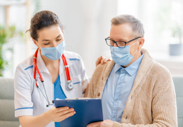 istock Doctor and senior man wearing facemasks 1273852479