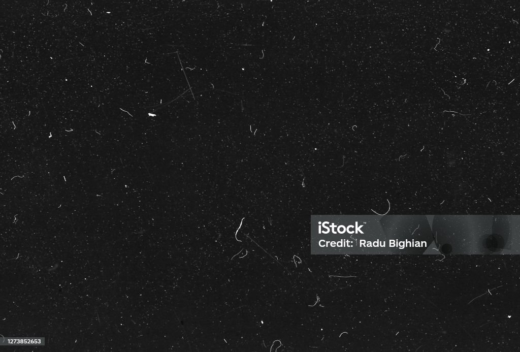 Old Scratched Film Strip Grunge Texture Background A close-up scan of an old scratched 35mm film strip grunge texture background. Textured Stock Photo