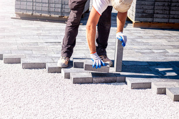istock Paver arranges cement paving stones 1273852834