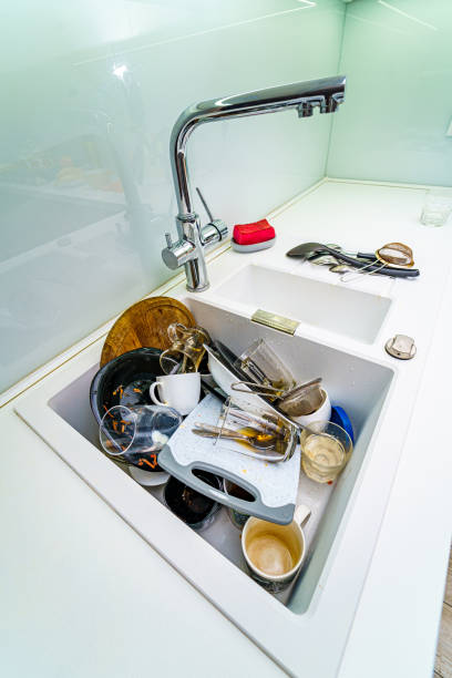 istock Dirty messy dishes in a sink. View from above. Clean up concept. 1273853935