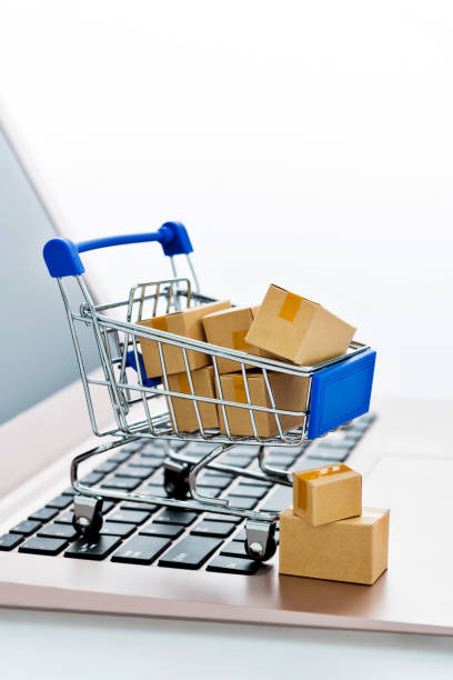 istock Shopping cart with small boxes on laptop keyboard 1273855432