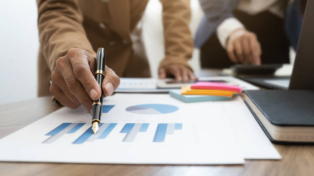istock Business team brainstorming and discussing with financial data and report graph. Teamwork meeting working concept. 1273859337