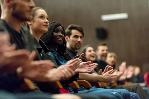 istock Happy people applauding in the theater 1273859656