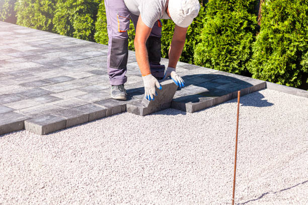 istock Paver arranges cement paving stones 1273860594