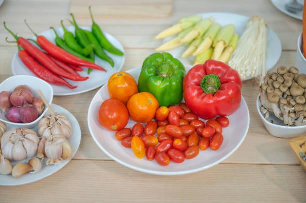 istock Fresh vegetable and fruit on wooden table in kitchen 1273861282