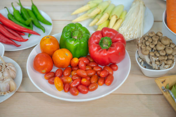 istock Fresh vegetable and fruit on wooden table in kitchen 1273861368