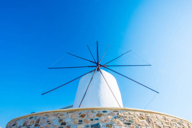 Windmill against blue sky. Forefront of the blades of windmill, Paros island, Greece