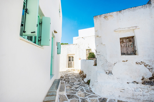 Old traditional white houses with turquoise windows in Lefkes village, Paros, Greece