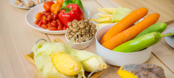 istock Fresh vegetable and fruit on wooden table in kitchen 1273862355