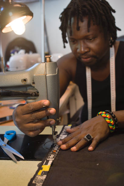 istock an attentive couturier sewing with his sewing machine 1273862937