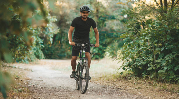 istock A man rides a bicycle through the forest, active lifestyle, sports 1273863021
