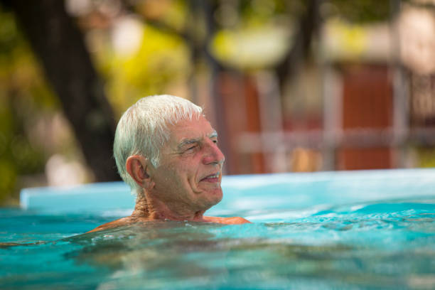 istock Content Senior Man Relaxing in Swimming Pool 1273863812