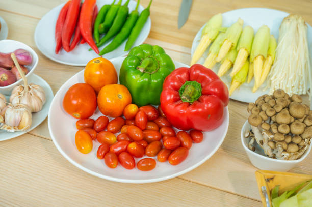 istock Fresh vegetable and fruit on wooden table in kitchen 1273864209