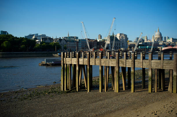 Victoria Embankment, London, England, UK, 22 April 2025: Daytime spring/summer urban view of central London cityscape along the River Thames. Thames buildings, the river, boats, and riverside walkways are partially visible. Clear sunny weather and bright daylight.