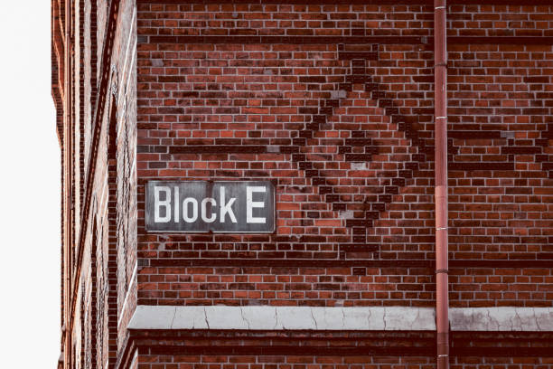 Hamburg, Germany - August 3, 2019: Block E building name sign in brick wall in the Warehouse District or Speicherstadt. It was built as a free zone to transfer goods without customs. UNESCO World Heritage Site